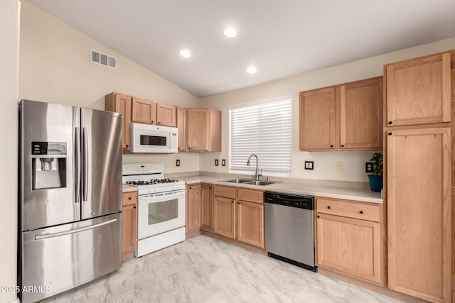 kitchen with stainless steel appliances, light countertops, a sink, and visible vents