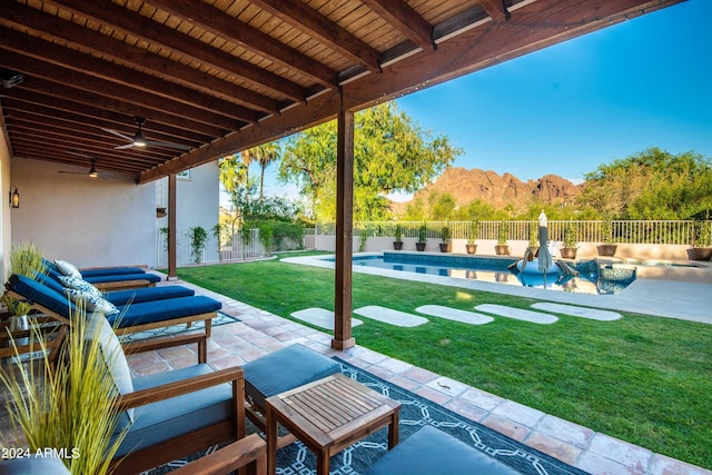 view of patio / terrace with a mountain view and a fenced in pool