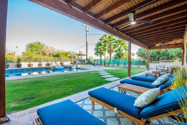 view of patio / terrace with a fenced in pool, outdoor lounge area, and ceiling fan