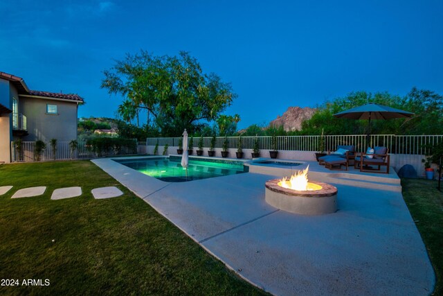 view of swimming pool featuring a fire pit, a patio, and a yard