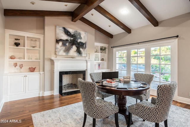 dining room featuring dark wood-type flooring and lofted ceiling with beams