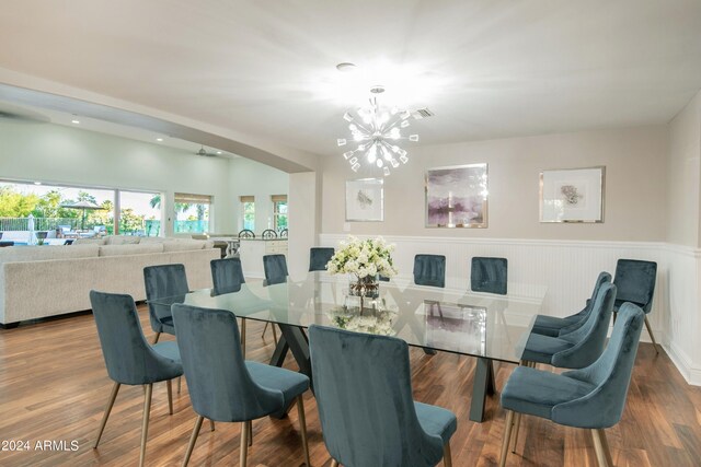 dining area featuring an inviting chandelier and hardwood / wood-style flooring