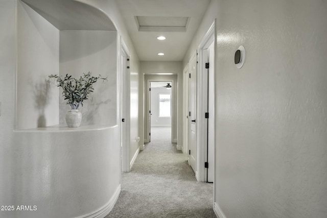 hallway featuring attic access, carpet floors, recessed lighting, and baseboards