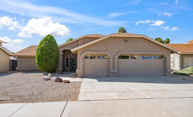4439 W Cielo Grande, Glendale, AZ 85310 - view of front of home featuring a garage, driveway, and stucco siding