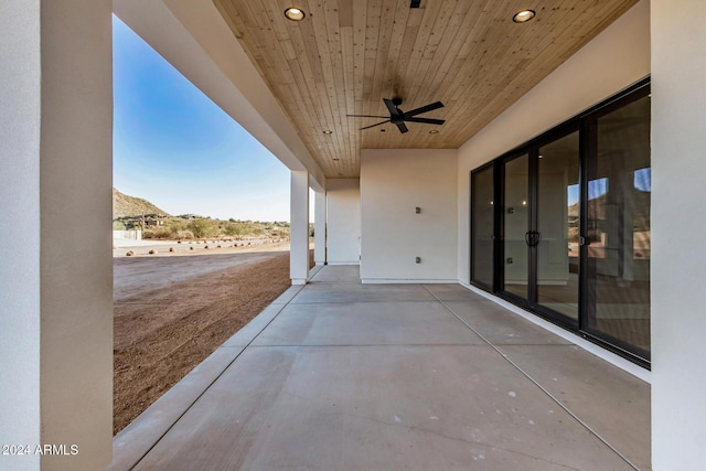 view of patio with a mountain view and ceiling fan