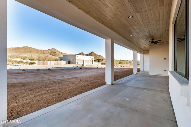 view of patio / terrace with a mountain view and ceiling fan