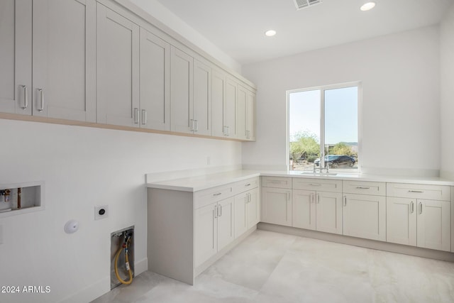 washroom featuring sink, cabinets, washer hookup, electric dryer hookup, and gas dryer hookup