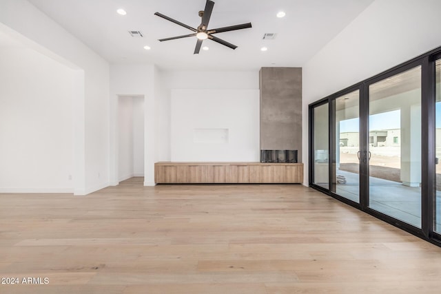 unfurnished living room featuring ceiling fan and light hardwood / wood-style flooring