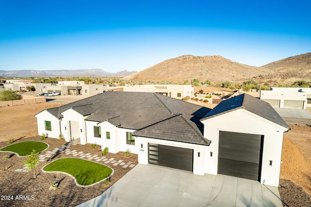 view of front of home featuring a mountain view and a garage