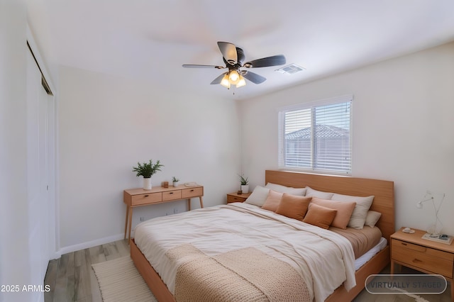 bedroom featuring a closet, visible vents, ceiling fan, wood finished floors, and baseboards