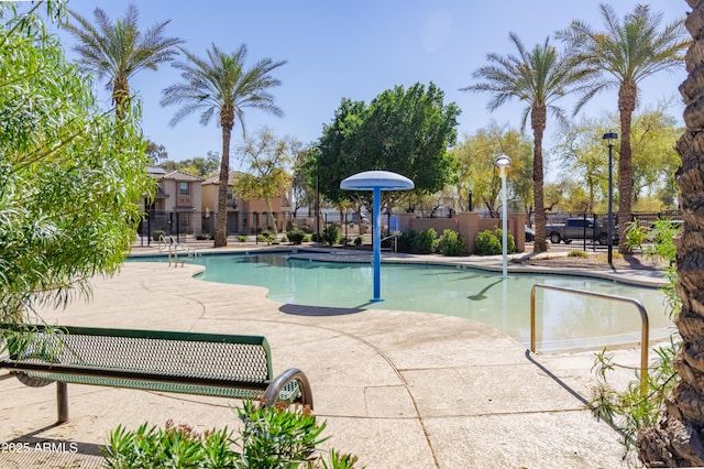 community pool featuring a patio area and fence