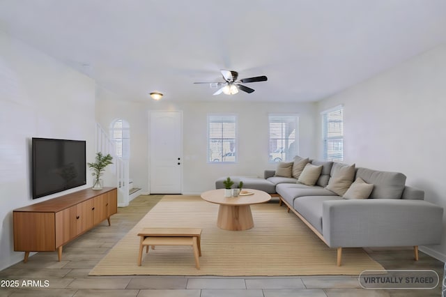 living room with a ceiling fan and light wood-style floors