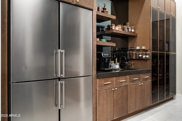 kitchen featuring sink and high quality fridge