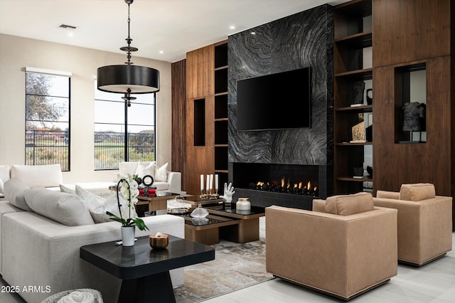 living room featuring a fireplace and built in features