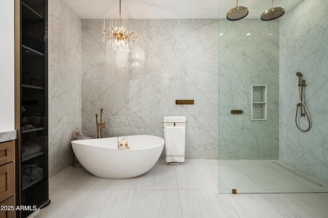 bathroom featuring plus walk in shower and a chandelier