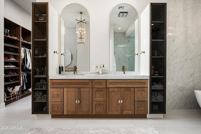 bathroom with vanity, a tub, and tile walls