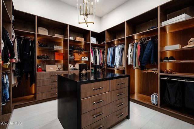 walk in closet with a notable chandelier