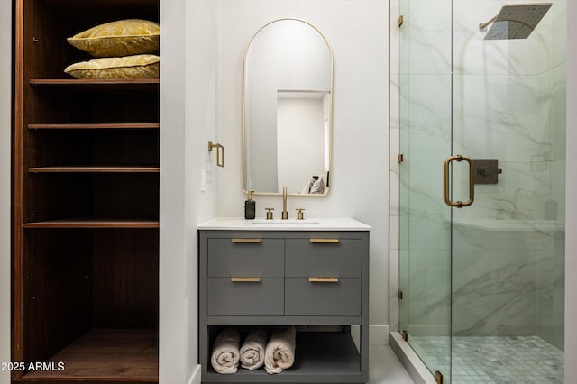 bathroom with vanity and a shower with shower door