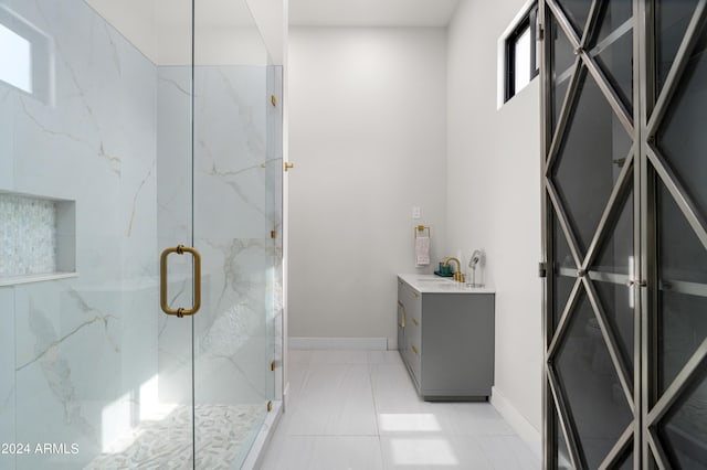 bathroom featuring vanity and a shower with shower door