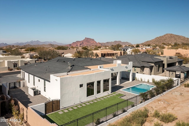 back of house with a mountain view and central air condition unit