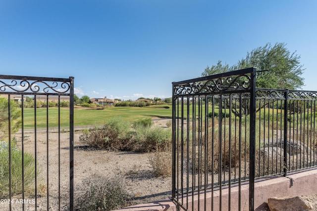 view of gate featuring a lawn