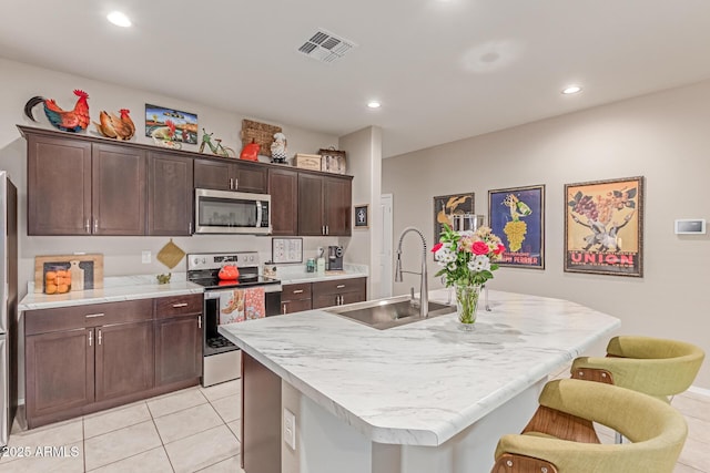 9429 E Grapefruit Dr, Florence, AZ 85132 - kitchen featuring appliances with stainless steel finishes, a sink, light tile patterned flooring, light countertops, and recessed lighting
