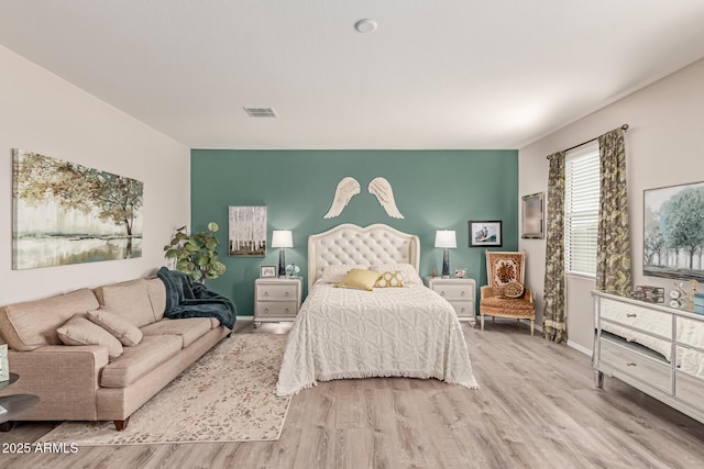 9429 E Grapefruit Dr, Florence, AZ 85132 - bedroom featuring wood finished floors, baseboards, and an accent wall