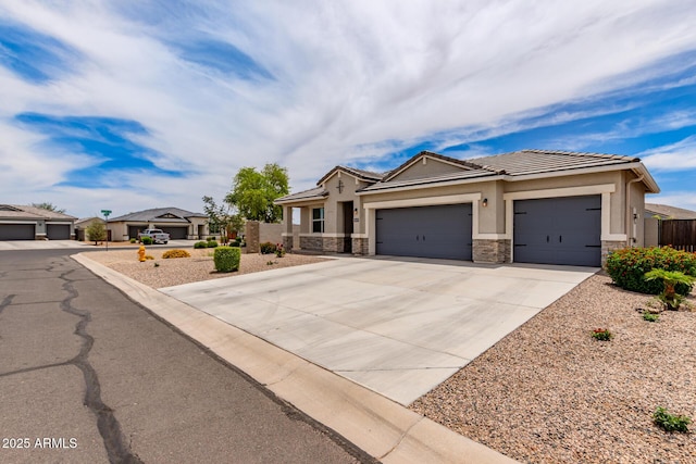 9429 E Grapefruit Dr, Florence, AZ 85132 - view of front of home with stone siding, an attached garage, driveway, a tile roof, and stucco siding