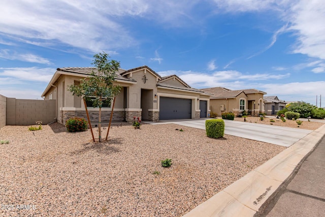 9429 E Grapefruit Dr, Florence, AZ 85132 - view of front of home with stone siding, driveway, an attached garage, and stucco siding