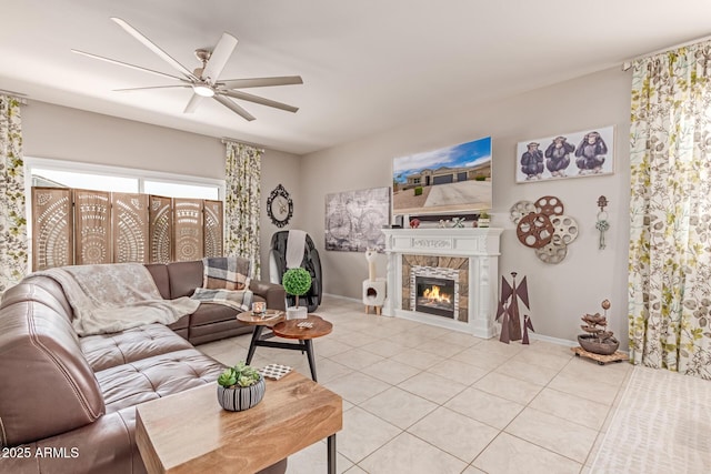 9429 E Grapefruit Dr, Florence, AZ 85132 - living room with ceiling fan, light tile patterned flooring, a tile fireplace, and baseboards