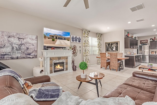 9429 E Grapefruit Dr, Florence, AZ 85132 - living area featuring ceiling fan, light tile patterned flooring, recessed lighting, and a tile fireplace