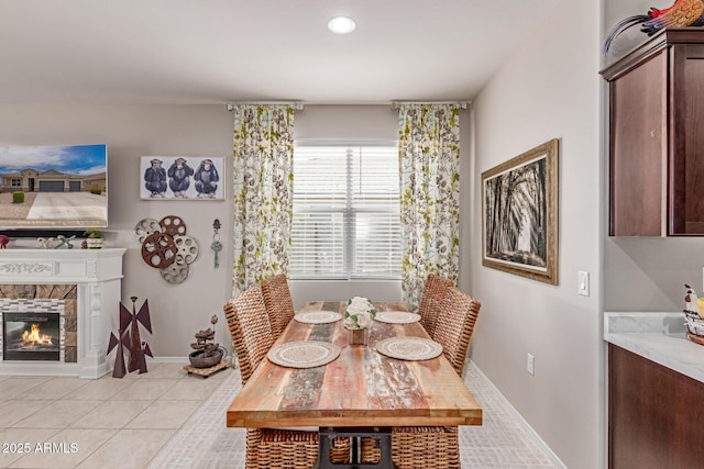 9429 E Grapefruit Dr, Florence, AZ 85132 - dining space with a fireplace, light tile patterned floors, recessed lighting, and baseboards