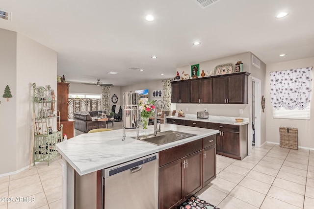9429 E Grapefruit Dr, Florence, AZ 85132 - kitchen with dishwasher, a sink, light tile patterned floors, baseboards, and open floor plan