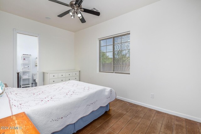 bedroom with dark hardwood / wood-style flooring and ceiling fan