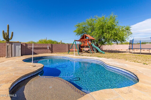 view of swimming pool featuring a playground, a trampoline, and a patio area