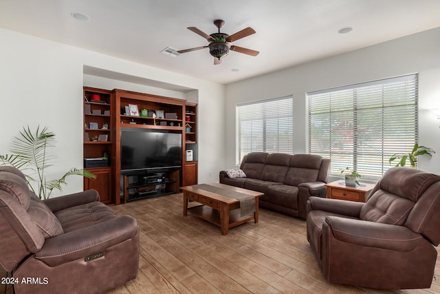 living room with hardwood / wood-style floors and ceiling fan