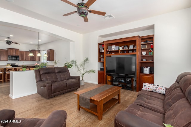 living room with ceiling fan and light hardwood / wood-style floors