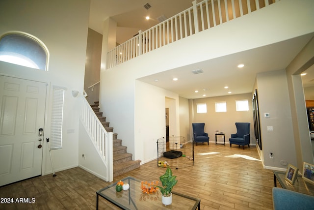 entrance foyer with a high ceiling and hardwood / wood-style floors