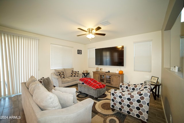 living room with ceiling fan and dark hardwood / wood-style flooring