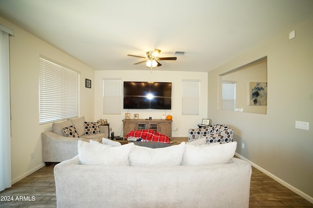 living room with ceiling fan and dark wood-type flooring