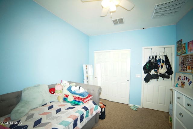 carpeted bedroom featuring two closets and ceiling fan