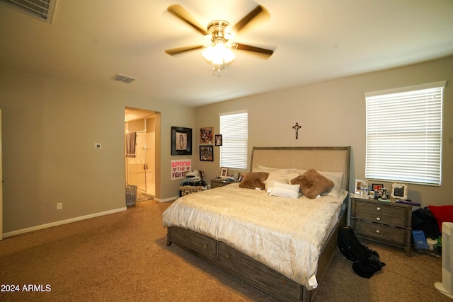 bedroom featuring ensuite bathroom, ceiling fan, and light colored carpet