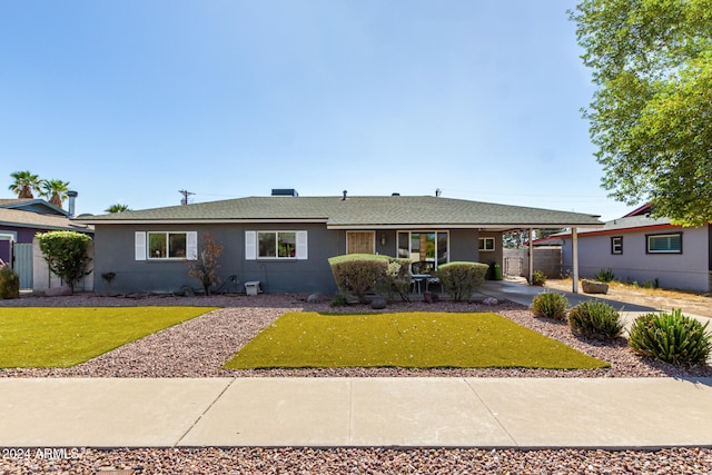 single story home featuring a front yard and a carport