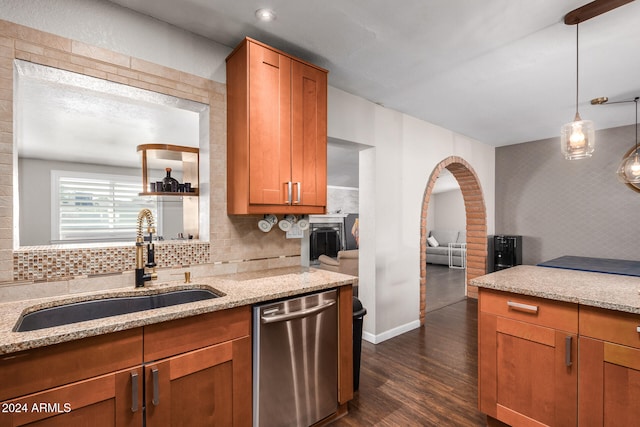 kitchen featuring sink, dishwasher, light stone countertops, and dark hardwood / wood-style flooring