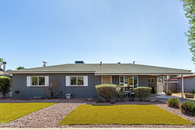 ranch-style house with a front yard and a carport