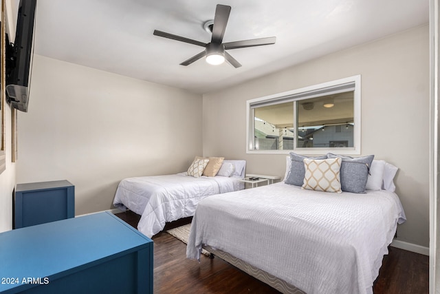 bedroom with dark wood-type flooring and ceiling fan