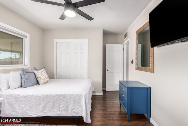 bedroom featuring dark hardwood / wood-style floors, a closet, and ceiling fan