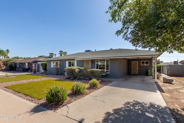 ranch-style house with a carport and a front lawn