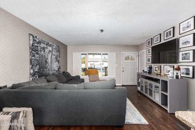 living room featuring a textured ceiling and dark hardwood / wood-style flooring