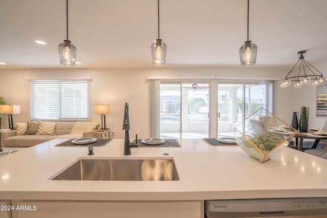 kitchen with dishwasher, pendant lighting, sink, and a healthy amount of sunlight